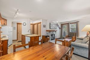 cocina y sala de estar con mesa y sofá en Lost Lake Lodge, en Whistler