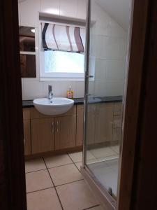 a bathroom with a sink and a glass shower door at Westwood Drive in Treharris +29 photos