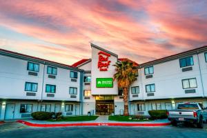 a hotel with a truck parked in front of it at Red Roof Inn San Antonio - Seaworld Northwest in San Antonio