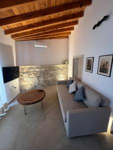 a living room with a couch and a table at The Courtyard Episkopi Guest Houses in Episkopi Limassol