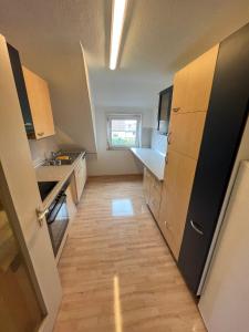 a small kitchen with a refrigerator and a sink at Monteurwohnung in Heilbronn