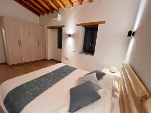a bedroom with a large white bed in a room at The Courtyard Episkopi Guest Houses in Episkopi Limassol