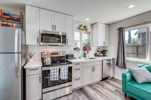 a kitchen with white cabinets and stainless steel appliances at Sacramento Studio with Private Yard 4 Mi to Dtwn! in Sacramento