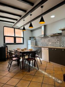 a kitchen with a table and chairs in a room at Alojamiento 13 Jotas in Iniesta