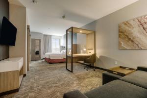 a hotel room with a bed and a desk at SpringHill Suites by Marriott Stillwater in Stillwater