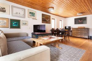 a living room with a couch and a table at Holiday Home Bela in Bohinjska Bela