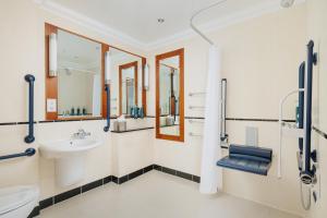 a bathroom with a sink and a toilet at DoubleTree by Hilton Hotel Newcastle International Airport in Newcastle upon Tyne