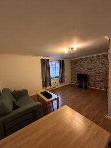 sala de estar con sofá y mesa en Spacious one bed flat in eastlondon with parking and free wifi en Goodmayes