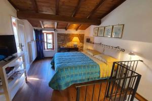 a bedroom with a bed and a desk and a television at Il Cantuccio 2 in Pescaglia