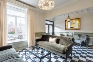a living room with a couch and a window at Stone Villa in Chester