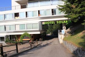 a building with a sign that reads holt sahalachi at Residence Albarè in Mezzana