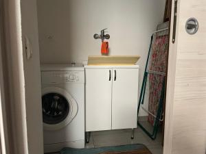 a laundry room with a washing machine and a washer at La casa di Rosetta in Levanto