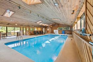a large swimming pool in a house with a ceiling at Large home with indoor heated pool! 