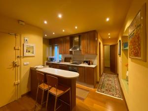 une cuisine avec des placards en bois et un comptoir blanc dans l'établissement Cozy flat in central Madrid with garage, à Madrid