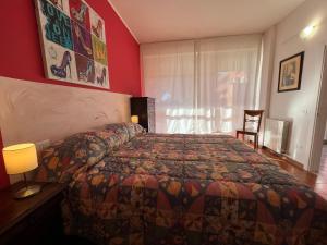 a hotel room with a bed and a window at Appartamento Fiore in Follonica