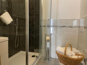 a bathroom with a shower and a basket on a toilet at La casa di Rosetta in Levanto