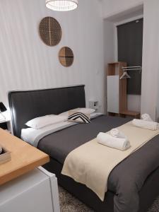 two beds sitting next to each other in a room at Homdwell Fine Living 2 in Ermoupoli