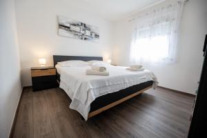 a bedroom with a bed with two towels on it at Villa Laura in Nadin +51 photos