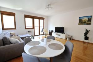 a living room with a white table and chairs at Captain's Luxury Apartments in Mostar