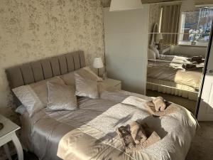a bedroom with a bed with a large mirror at 2-Bed Apartment in Coleshill in Birmingham