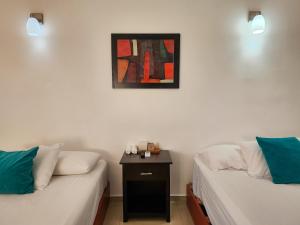 a room with two beds and a picture on the wall at Fitz-Mar in Isla Mujeres