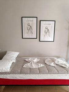 a bedroom with two pictures on the wall and a bed at Kalvou Flat2 in Thessaloniki