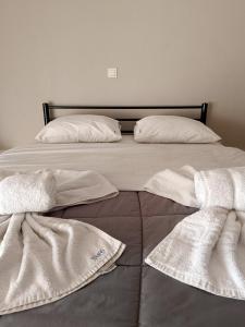 two beds with white sheets and pillows on them at Kalvou Flat2 in Thessaloniki +4 photos