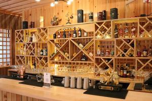 a bar with a bunch of bottles and glasses at Thimphu Deluxe Hotel in Thimphu