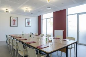 a large conference room with a long table and chairs at The Originals Residence, Le Wax, Lille Est in Villeneuve d'Ascq