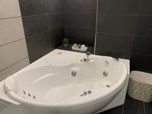 a white bath tub with a sink in a bathroom at The Inverleither in Edinburgh