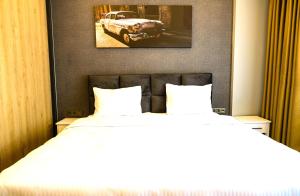 two beds in a hotel room with a car on the wall at Sing Of Hotel & Suites Taksim Istanbul in Istanbul