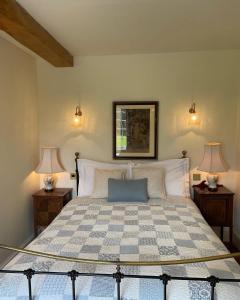 a bedroom with a large bed with two lamps at Wethele Manor in Leamington Spa