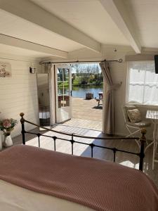 a bedroom with a bed and a view of a patio at Wethele Manor in Leamington Spa