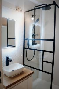 a bathroom with a sink and a shower at Charmant Appartement Les temples du Soleil in Font-Romeu-Odeillo-Via