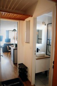 a room with a bathroom with a sink in it at Charmant Appartement Les temples du Soleil in Font-Romeu-Odeillo-Via