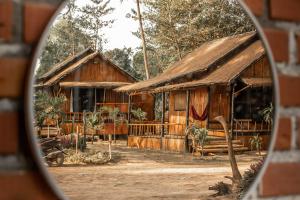 a reflection of a building in a mirror at Eco Lanta Hideaway Beach Resort in Ko Lanta