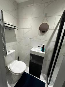 a white bathroom with a toilet and a sink at Stunning 1-Bed Apartment in Lewisham SE14 in London