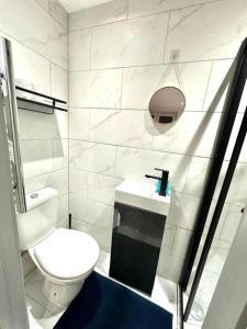 a white bathroom with a toilet and a sink at Stunning 1-Bed Apartment in Lewisham SE14 in London