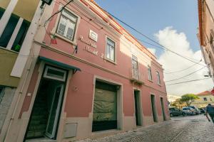 a pink building on the side of a street at Best Houses Portugal Residence in Peniche