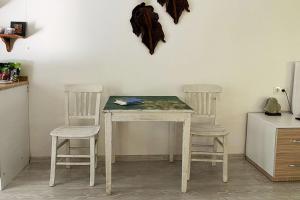 a table and two chairs in a room at King Tombs Suit in Mugla