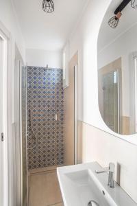 a bathroom with a sink and a shower with a mirror at Il Borgo in Formia
