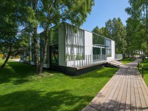 a building in a park with green grass at Rosevia Resort & Spa in Jastrzębia Góra