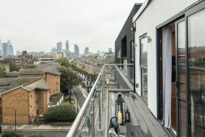 a balcony with a view of a city at BethnalGreen Apartments by Sleepy in London