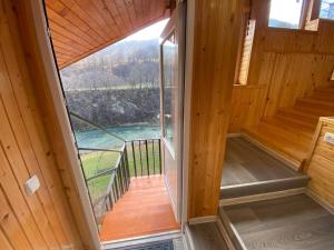 a view from the inside of a wooden cabin with a window at Акорди Плеса in Yaremche