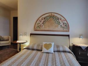 a bedroom with a bed with a heart pillow on it at Elis' House in Moriago della Battaglia