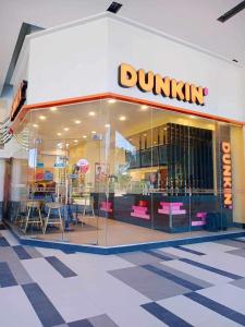 a dunkin donuts store with a large glass window at Mactan Cebu Beach Condo in Punta Engaño