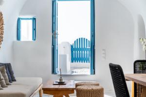 a living room with a chair and a table at Nano Armonia Villas in Oia