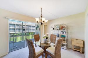 a dining room with a table and chairs and a window at Sanibel Siesta on the Beach unit 501 condo in Sanibel
