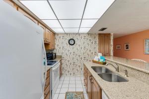 a kitchen with a sink and a stove at Sanibel Siesta on the Beach unit 501 condo in Sanibel