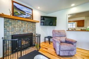 a living room with a chair and a fireplace at Pet-Friendly Roanoke Home with Fire Pit and Grill! in Roanoke